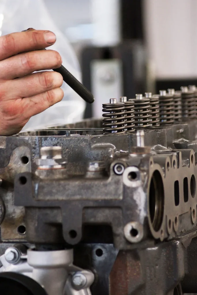 Mechaniker montiert Ventilfedern am Zylinderkopf eines Dieselmotors